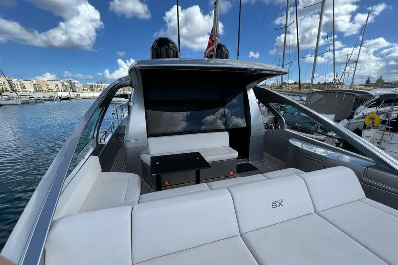 Rivo Co Rivo Yacht Photos Pics 2019 Pershing 5x yacht with sleek design docked in a marina under blue skies.