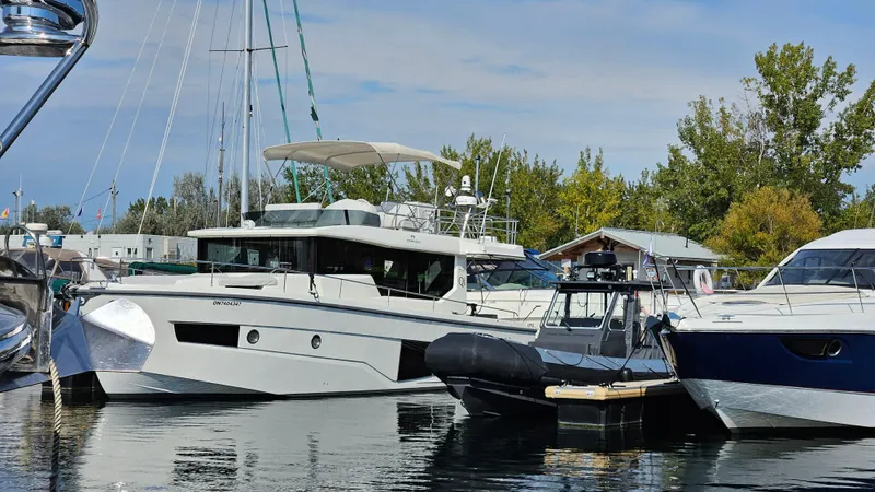  Yacht Photos Pics 2021 Cranchi Eco Trawler T43 Long Distance docked at a marina, surrounded by other boats.