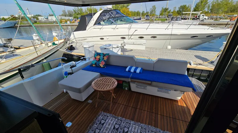  Yacht Photos Pics Outdoor seating area on 2021 Cranchi Eco Trawler T43 Long Distance yacht, docked at marina.