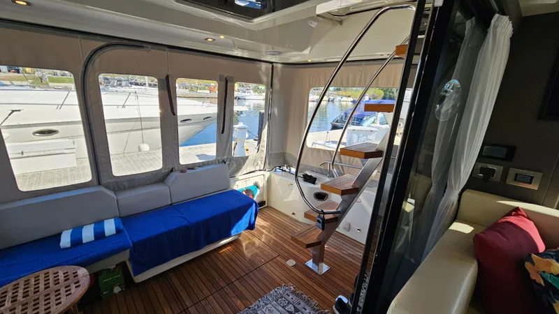  Yacht Photos Pics Interior of 2021 Cranchi Eco Trawler T43, featuring cozy seating and elegant wooden flooring.