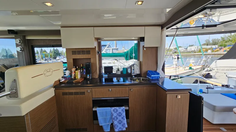  Yacht Photos Pics Interior of 2021 Cranchi Eco Trawler T43 Long Distance yacht, featuring modern kitchen and marina view.