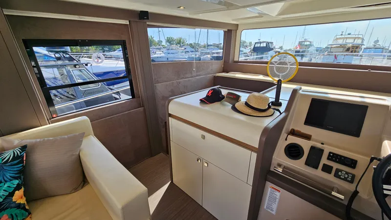  Yacht Photos Pics Interior of 2021 Cranchi Eco Trawler T43, featuring helm and seating area with marina view.