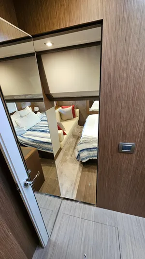  Yacht Photos Pics 2021 Cranchi Eco Trawler T43 cabin interior with modern wood finish and cozy bedding.