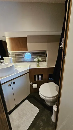  Yacht Photos Pics 2021 Cranchi Eco Trawler T43 bathroom with modern fixtures and porthole window.