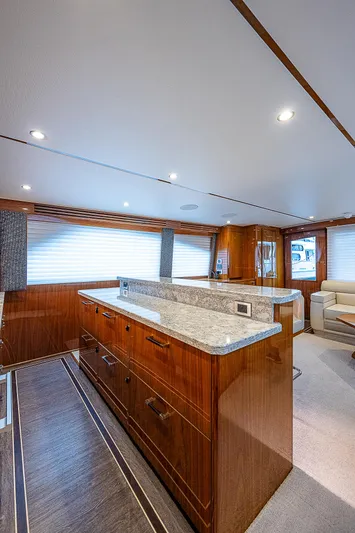 City Hands Yacht Photos Pics Modern kitchen interior of 2020 Viking 68 Convertible yacht with wooden cabinetry and granite countertops.