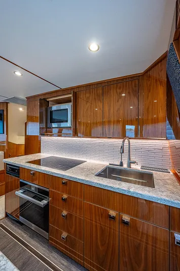 City Hands Yacht Photos Pics Modern kitchen in 2020 Viking 68 Convertible yacht with sleek wood cabinetry.