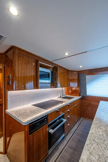 City Hands Yacht Photos Pics Modern kitchen in 2020 Viking 68 Convertible yacht with sleek countertops and wooden cabinetry.