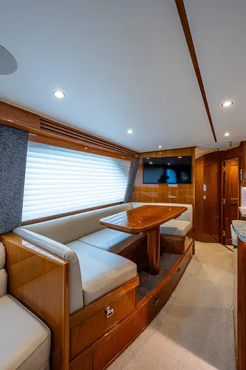 City Hands Yacht Photos Pics Interior of 2020 Viking 68 Convertible yacht with dining area and TV.