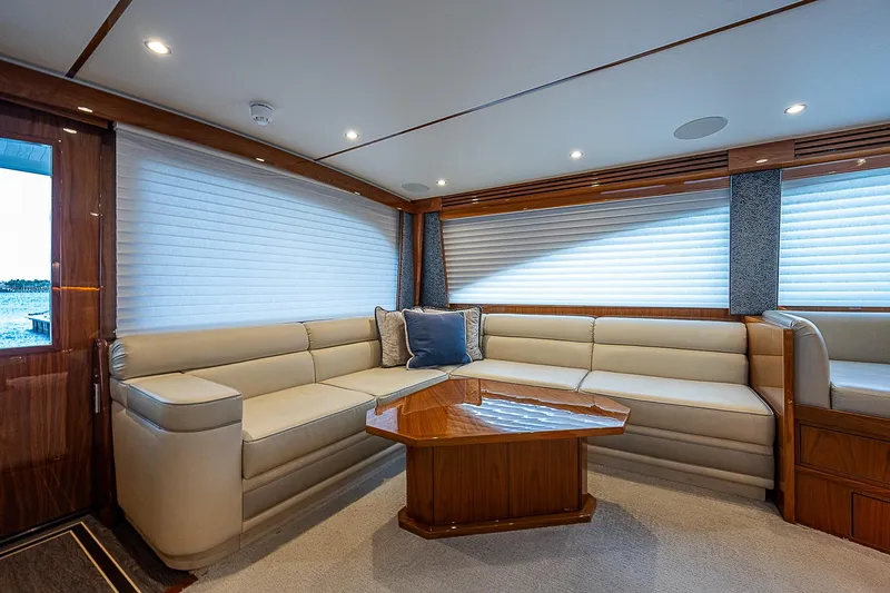 City Hands Yacht Photos Pics Luxurious interior of 2020 Viking 68 Convertible yacht with plush seating and wooden table.