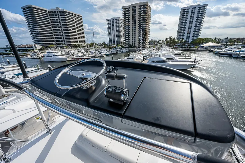 City Hands Yacht Photos Pics 2020 Viking 68 Convertible yacht helm with marina and high-rise buildings in background.