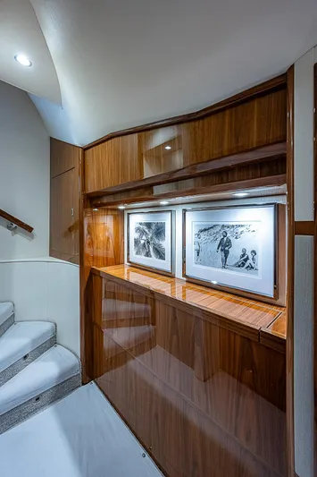 City Hands Yacht Photos Pics 2020 Viking 68 Convertible yacht interior with wooden cabinetry and framed artwork.