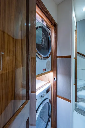 City Hands Yacht Photos Pics Laundry area inside 2020 Viking 68 Convertible yacht with stacked washer and dryer.