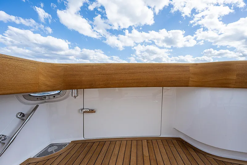 City Hands Yacht Photos Pics Viking 68 Convertible 2020 yacht deck with teak flooring and blue sky background.