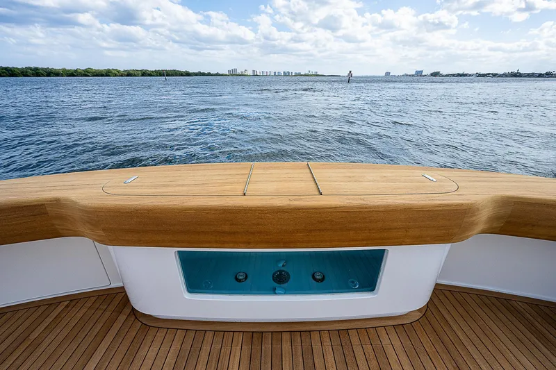 City Hands Yacht Photos Pics Stern view of 2020 Viking 68 Convertible yacht with teak deck and ocean backdrop.