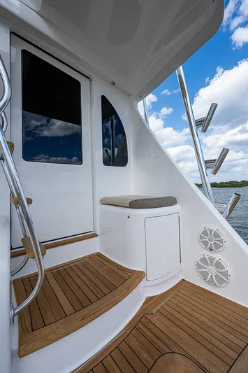 City Hands Yacht Photos Pics 2020 Viking 68 Convertible yacht deck with wooden steps and seating.