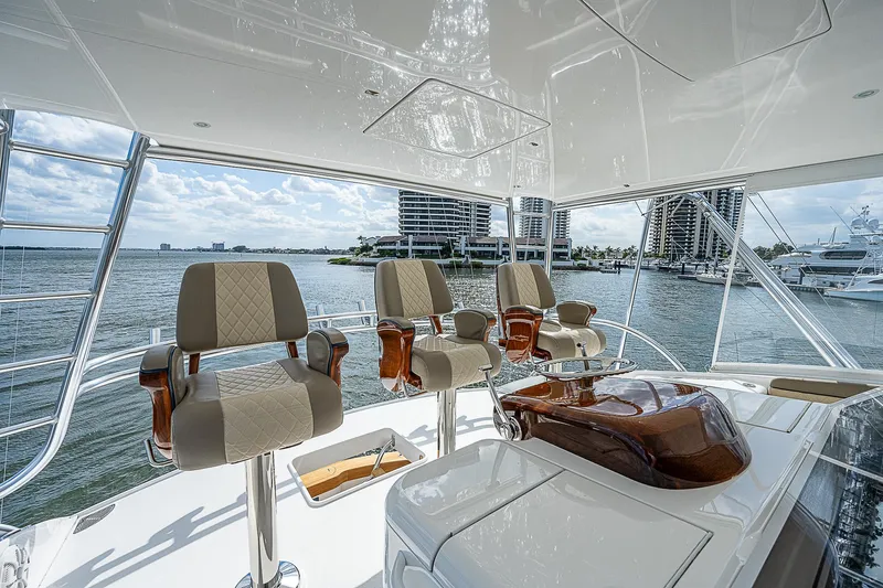 City Hands Yacht Photos Pics Luxurious helm station on a 2020 Viking 68 Convertible yacht with waterfront view.