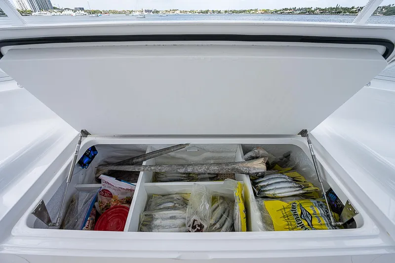 City Hands Yacht Photos Pics Open storage compartment on a 2020 Viking 68 Convertible boat filled with fishing supplies.