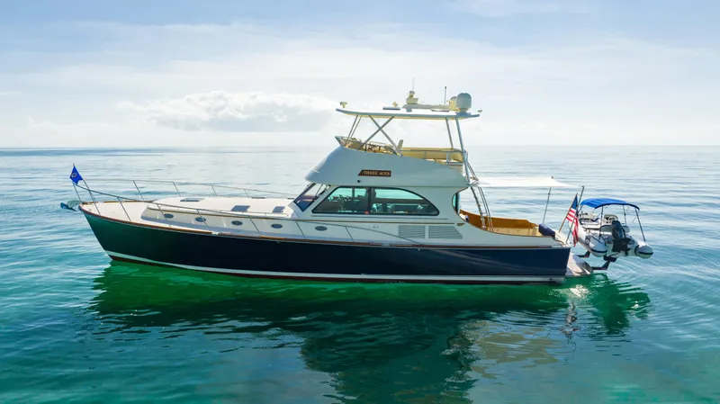 Three Aces Yacht Photos Pics 2007 Hinckley Talaria 55 FB yacht on calm ocean waters under clear skies.