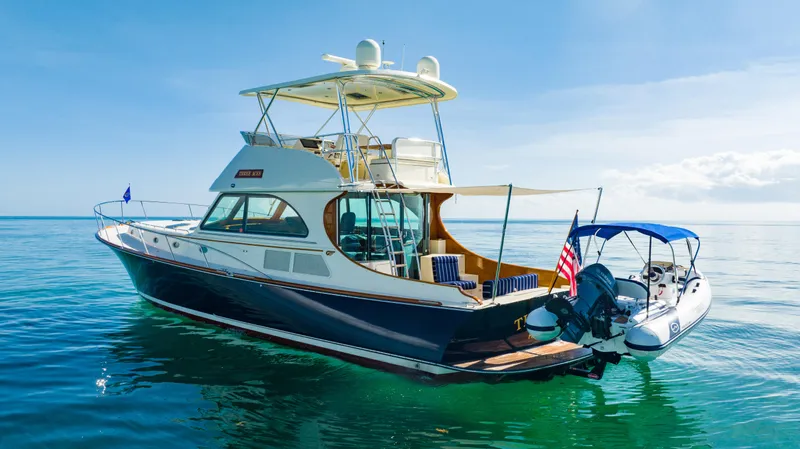 Three Aces Yacht Photos Pics 2007 Hinckley Talaria 55 FB yacht on calm blue water, rear view.
