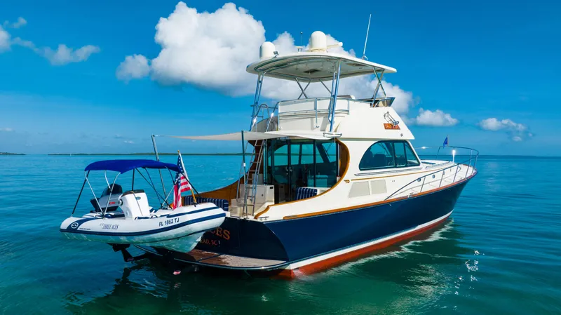 Three Aces Yacht Photos Pics 2007 Hinckley Talaria 55 FB yacht on calm blue waters.