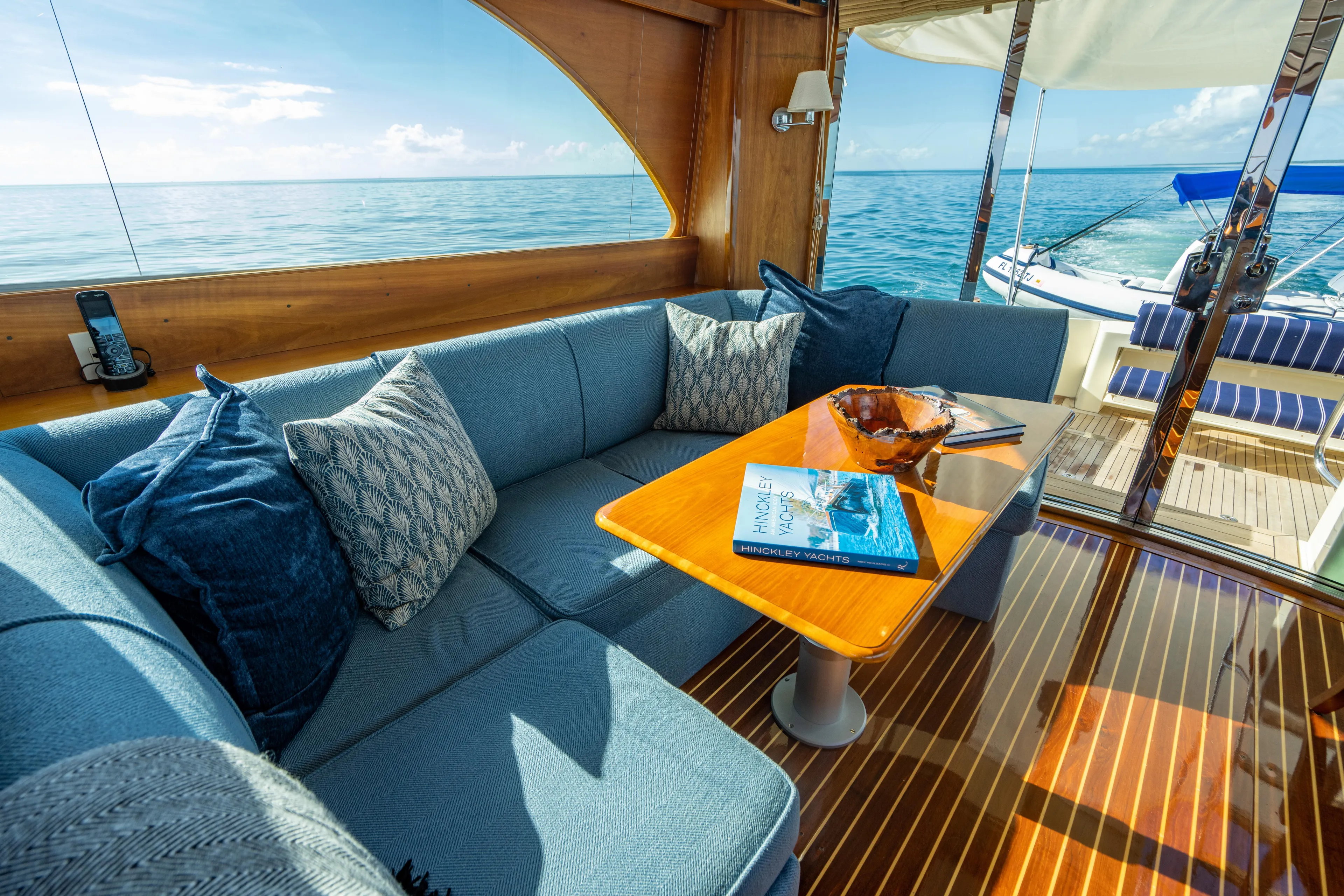 Three Aces Yacht Photos Pics Luxurious 2007 Hinckley Talaria 55 FB yacht interior with ocean view and elegant seating area.