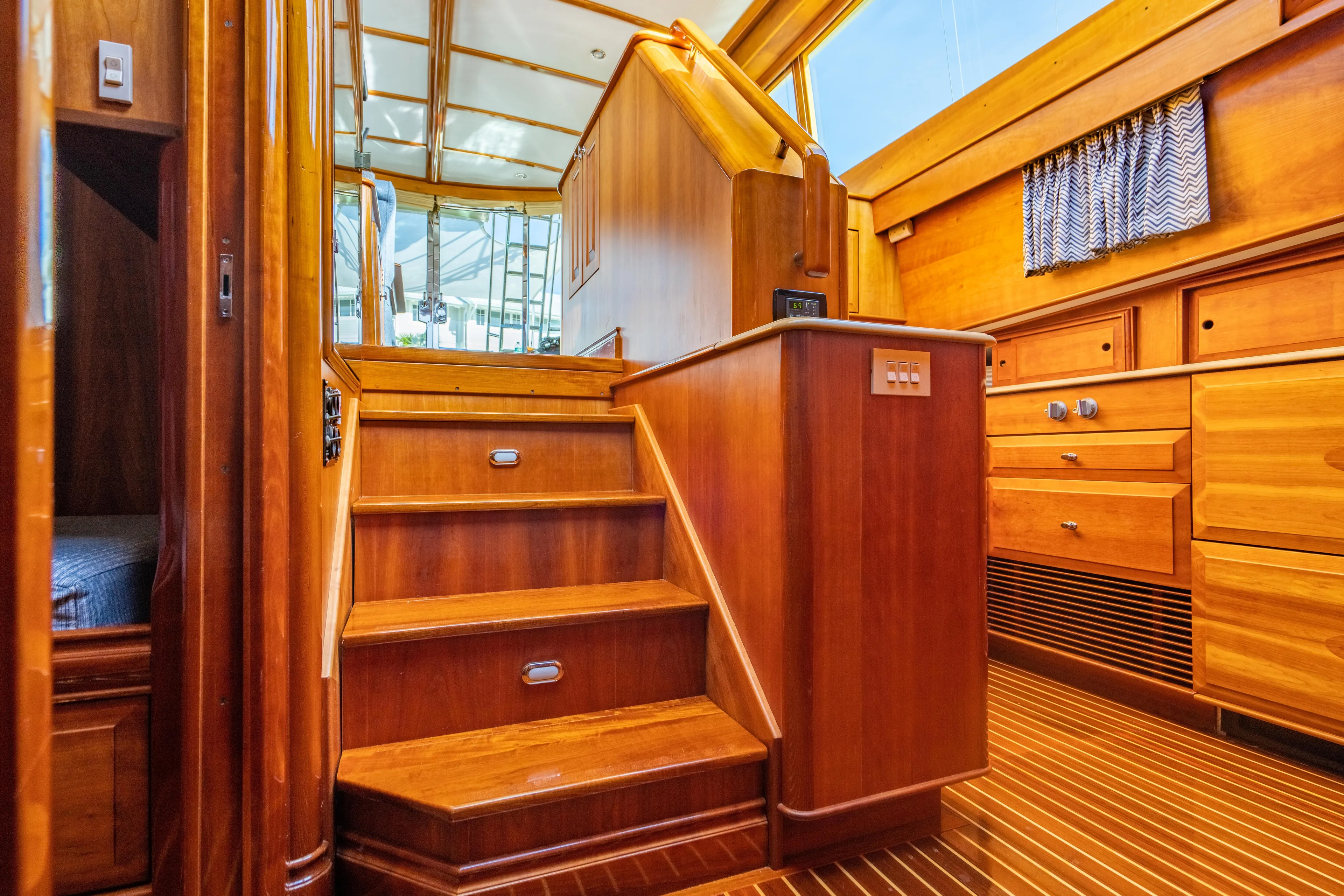 Three Aces Yacht Photos Pics Interior of 2007 Hinckley Talaria 55 FB yacht with wooden stairs and cabinetry.