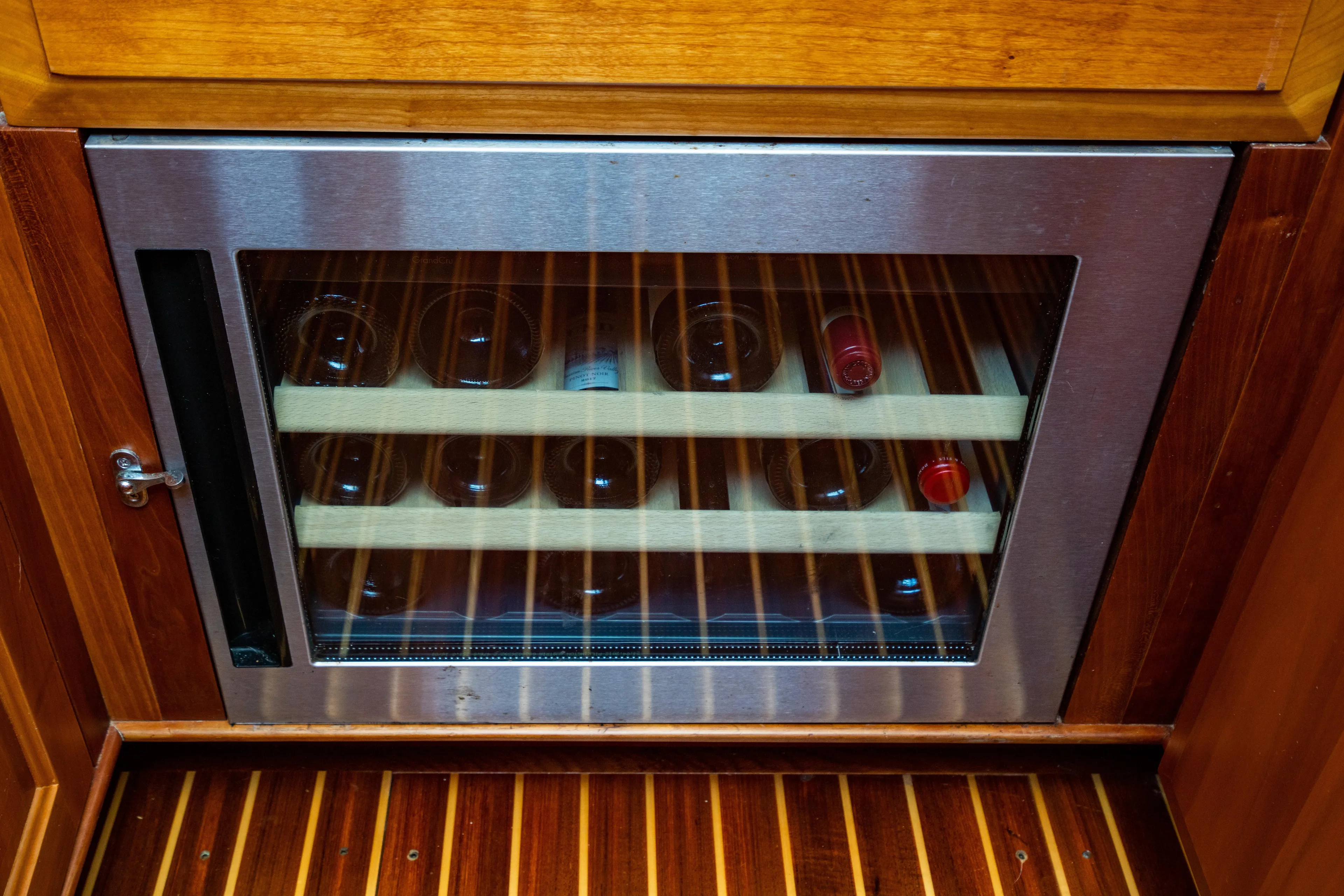 Three Aces Yacht Photos Pics Wine cooler with wooden shelves in 2007 Hinckley Talaria 55 FB yacht interior.