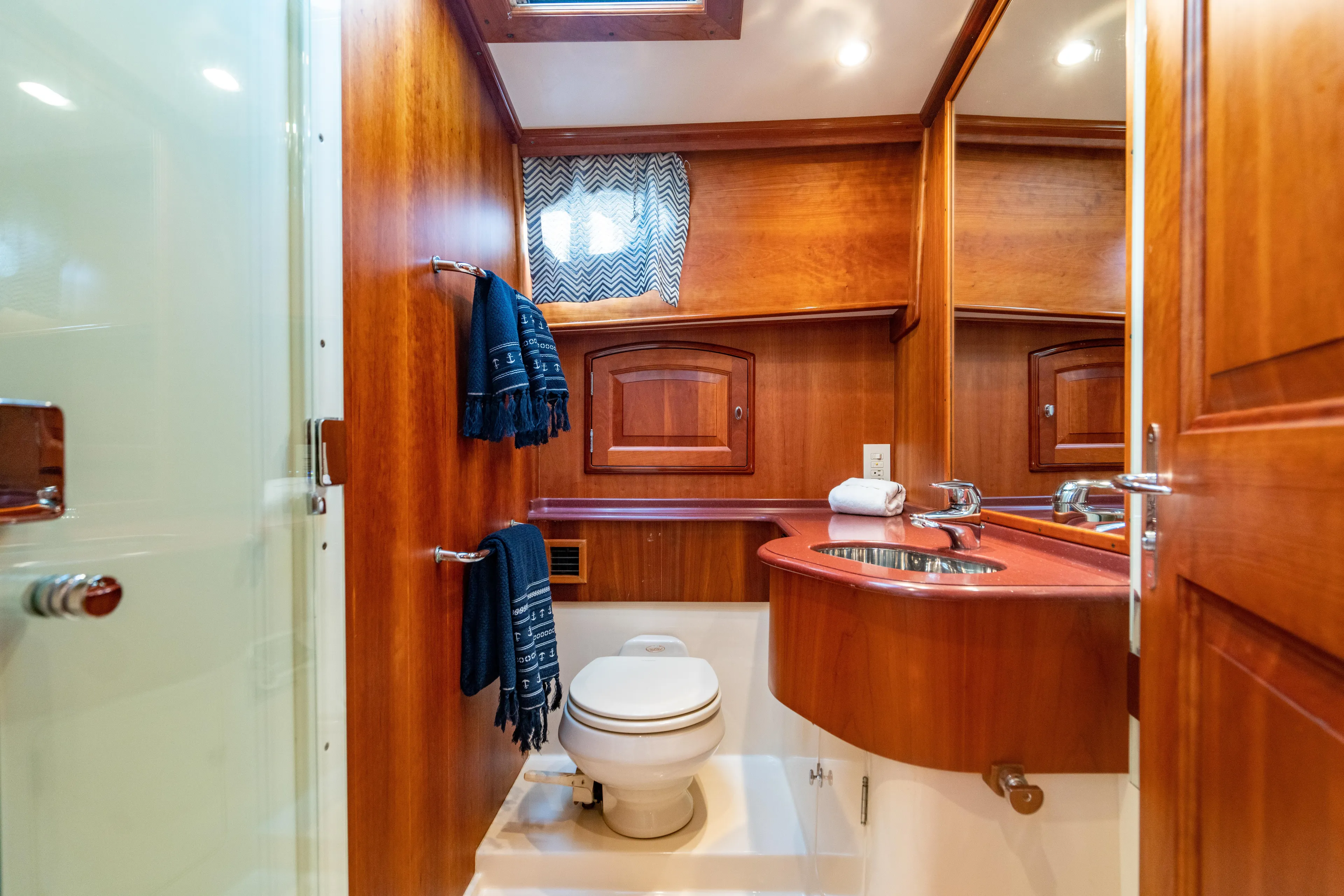 Three Aces Yacht Photos Pics Luxurious 2007 Hinckley Talaria 55 FB yacht bathroom with wood accents and modern fixtures.