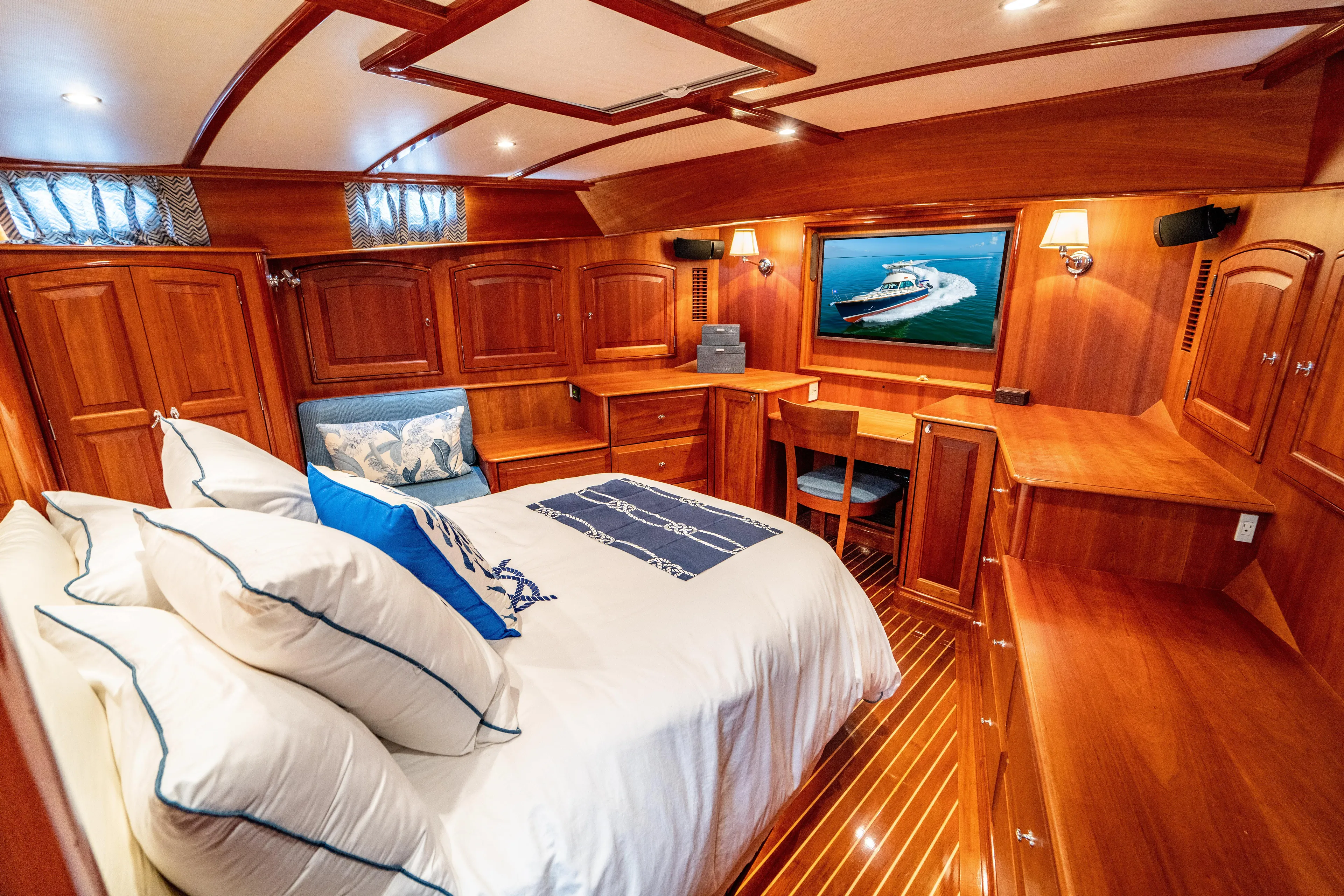 Three Aces Yacht Photos Pics Luxurious 2007 Hinckley Talaria 55 FB yacht cabin with elegant wood interior and cozy bedding.