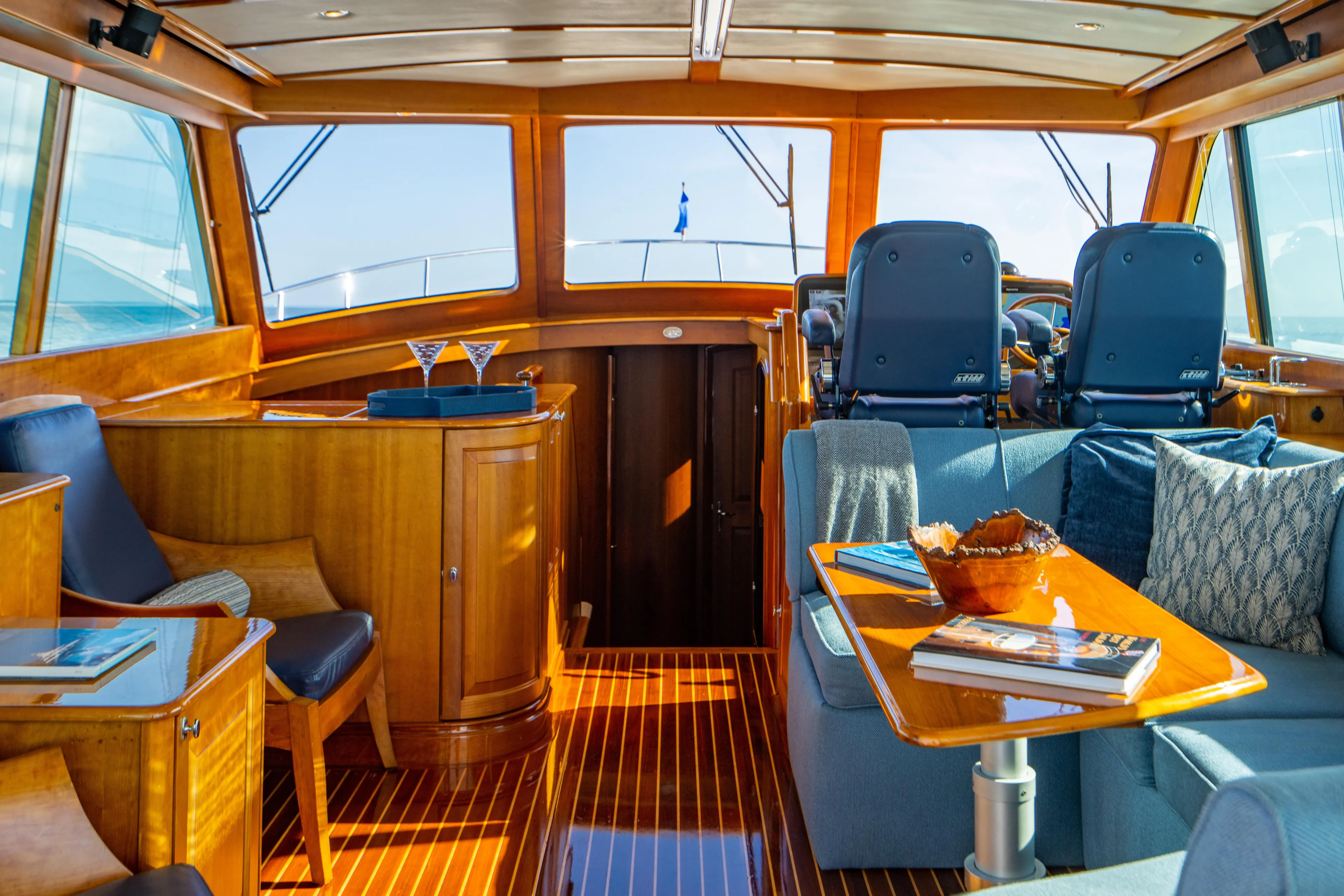 Three Aces Yacht Photos Pics Luxurious 2007 Hinckley Talaria 55 FB yacht interior with elegant wood finish and plush seating.