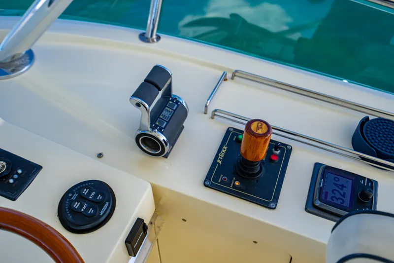 Three Aces Yacht Photos Pics Control panel of a 2007 Hinckley Talaria 55 FB yacht with throttle and navigation instruments.