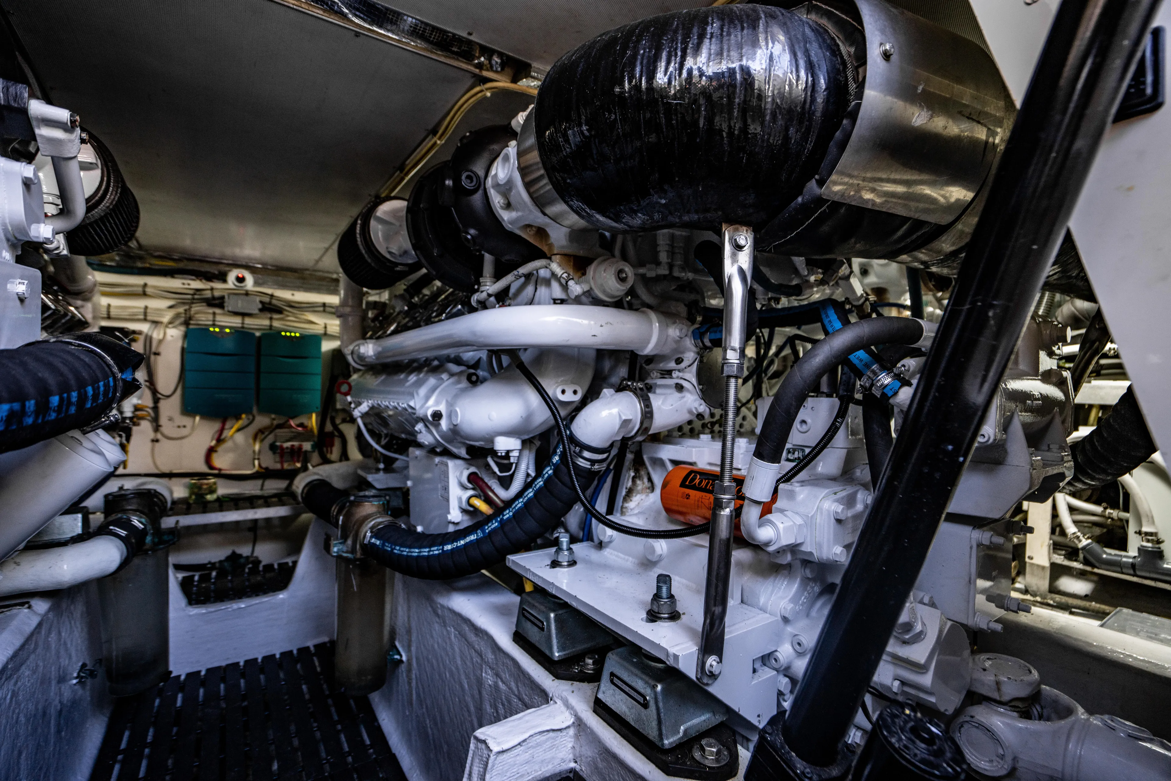 Three Aces Yacht Photos Pics Engine room of 2007 Hinckley Talaria 55 FB yacht, showcasing complex machinery and components.