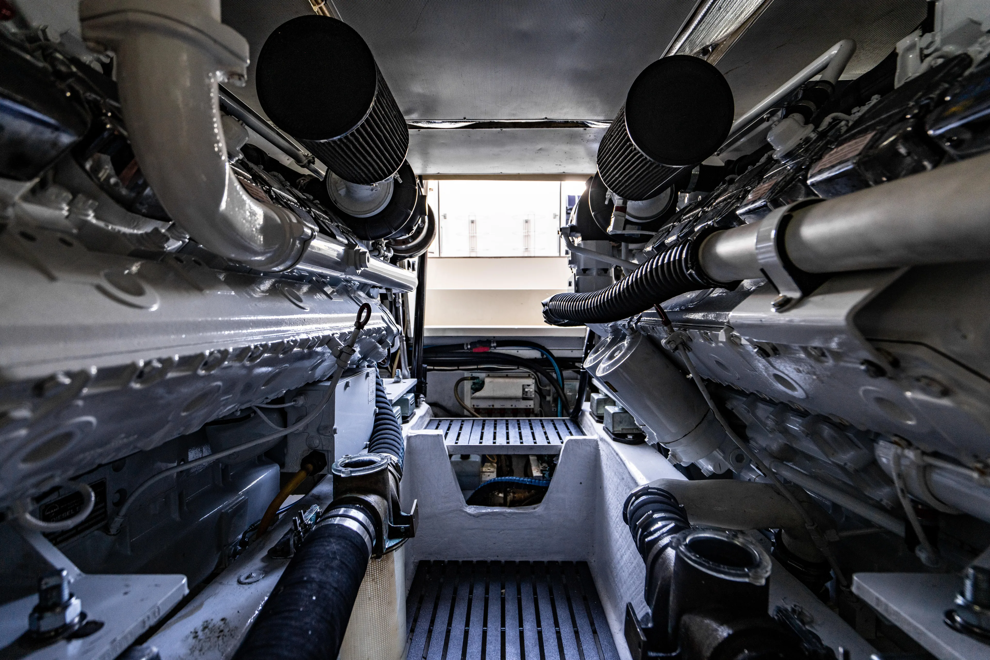 Three Aces Yacht Photos Pics Engine room of 2007 Hinckley Talaria 55 FB yacht, showcasing dual engines and mechanical components.