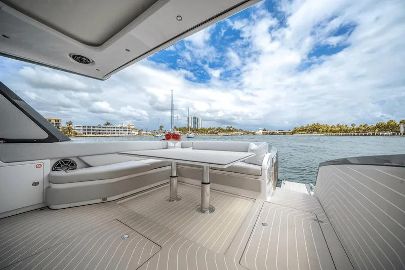  Yacht Photos Pics Luxurious 2025 Azimut Verve 48 yacht deck with seating, table, and scenic ocean view.