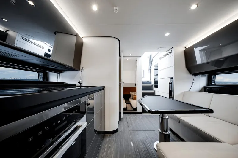  Yacht Photos Pics Luxurious interior of 2025 Azimut Verve 48 yacht with modern kitchen and seating area.