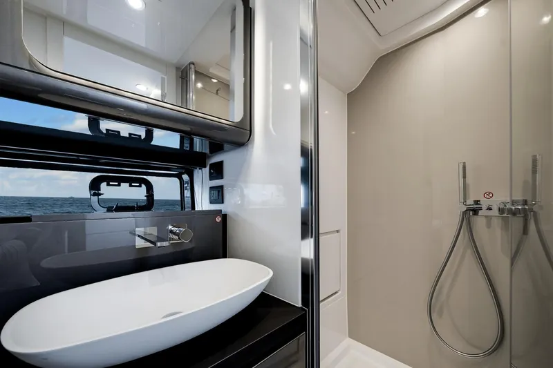  Yacht Photos Pics Luxurious bathroom interior of 2025 Azimut Verve 48 yacht with modern fixtures and ocean view.