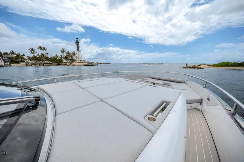  Yacht Photos Pics Azimut Verve 48 yacht, 2025 model, cruising near a lighthouse and palm trees.