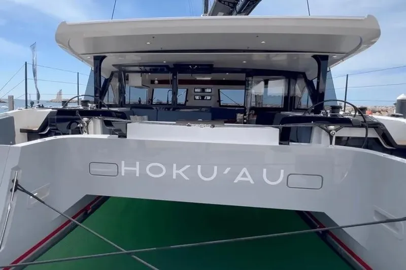 Hoku'au Yacht Photos Pics 2025 HH Catamarans HH44 yacht, rear view, docked with visible steering wheels and deck.