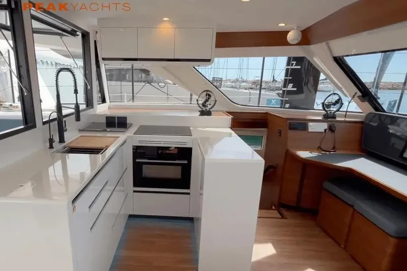 Hoku'au Yacht Photos Pics Modern kitchen interior of 2025 HH Catamarans HH44 yacht, featuring sleek design and ample natural light.