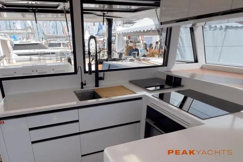 Hoku'au Yacht Photos Pics Modern kitchen interior of 2025 HH Catamarans HH44 yacht, featuring sleek design and appliances.