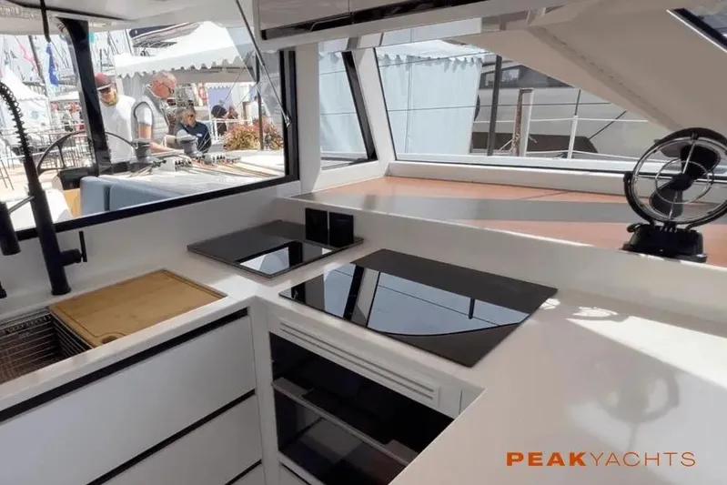 Hoku'au Yacht Photos Pics Modern kitchen interior of 2025 HH Catamarans HH44 yacht, featuring sleek design and appliances.