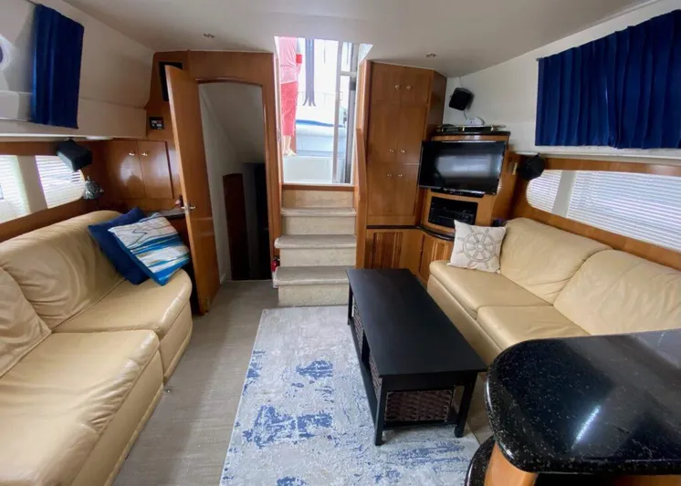  Yacht Photos Pics Interior of 2001 Carver 444 Cockpit Motor Yacht with beige sofas and blue accents.