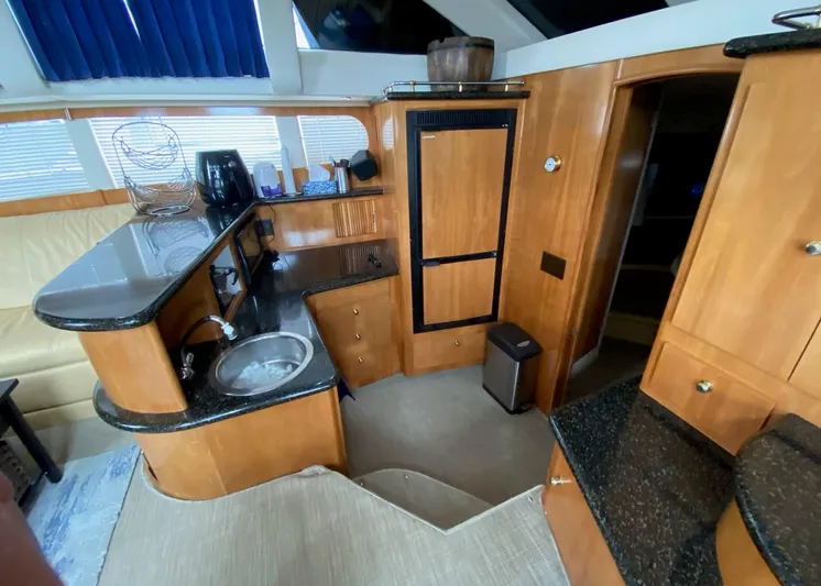  Yacht Photos Pics 2001 Carver 444 Cockpit Motor Yacht interior with kitchenette and seating area.