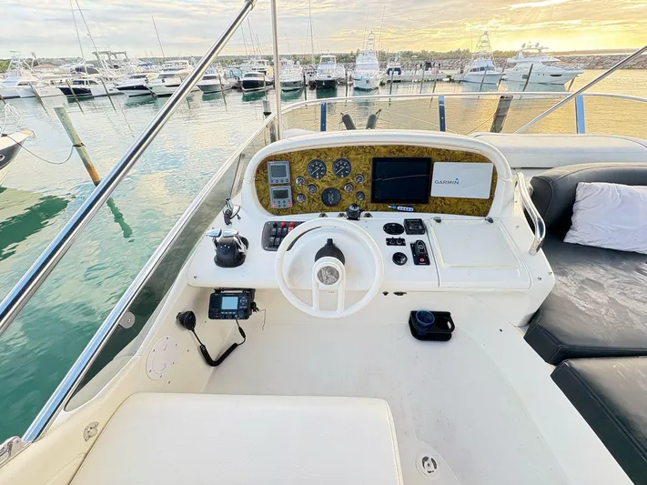  Yacht Photos Pics 2004 Azimut 62 Flybridge yacht helm with marina view at sunset.