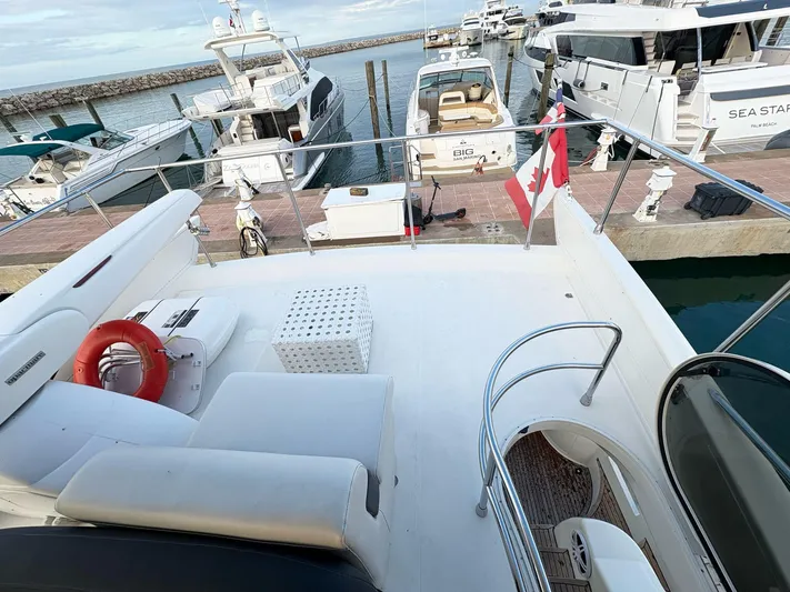  Yacht Photos Pics Flybridge view of 2004 Azimut 62 yacht docked at marina with Canadian flag.