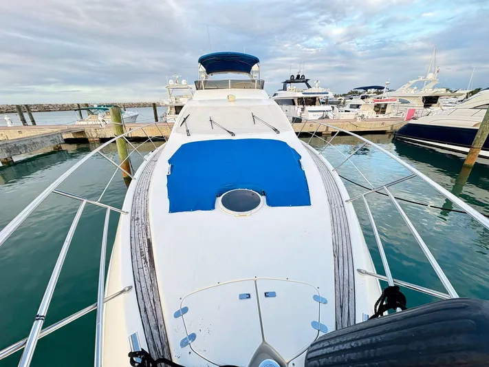  Yacht Photos Pics 2004 Azimut 62 Flybridge yacht docked at marina, featuring spacious deck and sleek design.