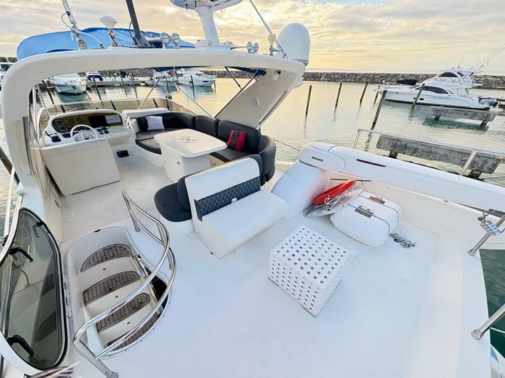  Yacht Photos Pics 2004 Azimut 62 Flybridge yacht with spacious deck and seating, docked at marina.