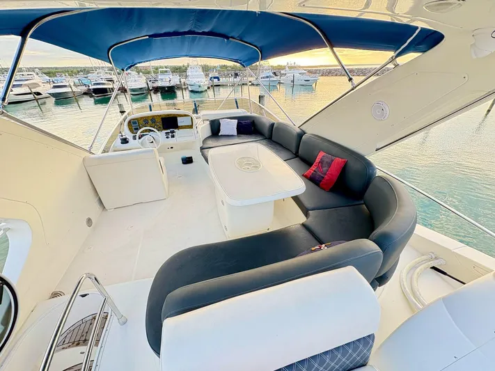 Yacht Photos Pics Luxurious 2004 Azimut 62 Flybridge yacht with spacious seating and elegant design.