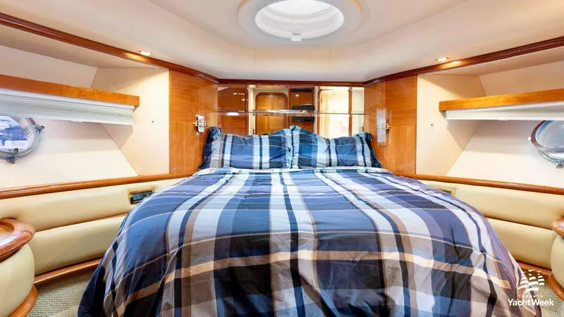  Yacht Photos Pics Luxurious bedroom interior of 2004 Azimut 62 Flybridge yacht with plaid bedding.