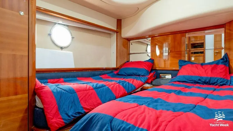  Yacht Photos Pics Luxurious cabin interior of 2004 Azimut 62 Flybridge yacht with twin beds and vibrant bedding.